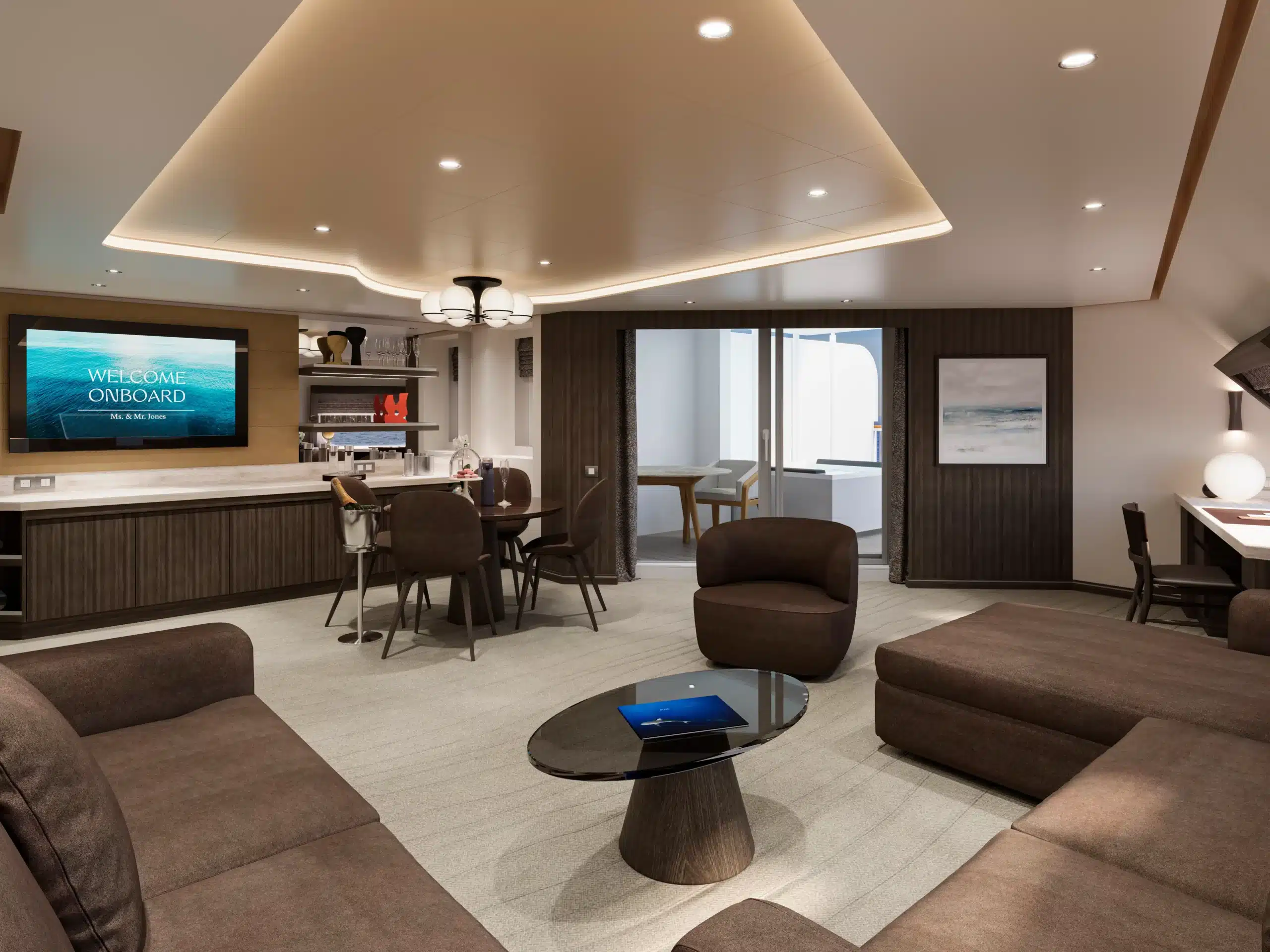 Interieur van de Porthole Suite slaapkamer op de EXPLORA V, met een luxueus bed, een geïntegreerd bureau met make-up spiegel, een hoed en een flesje parfum.