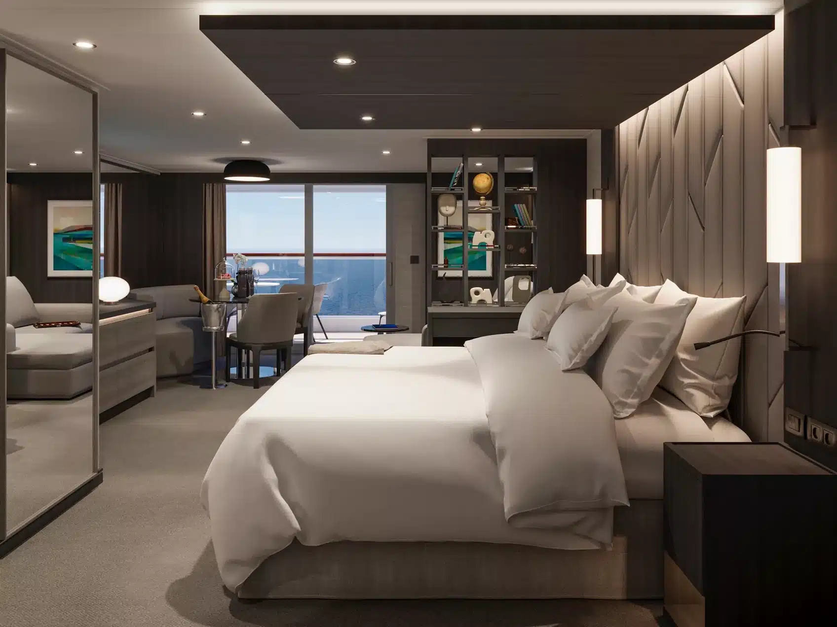 Interieur van een Ocean Penthouse op de EXPLORA V, met een focus op het slaapgedeelte, een roomdivider met boekenkast en een aangrenzende zithoek bij het balkon.