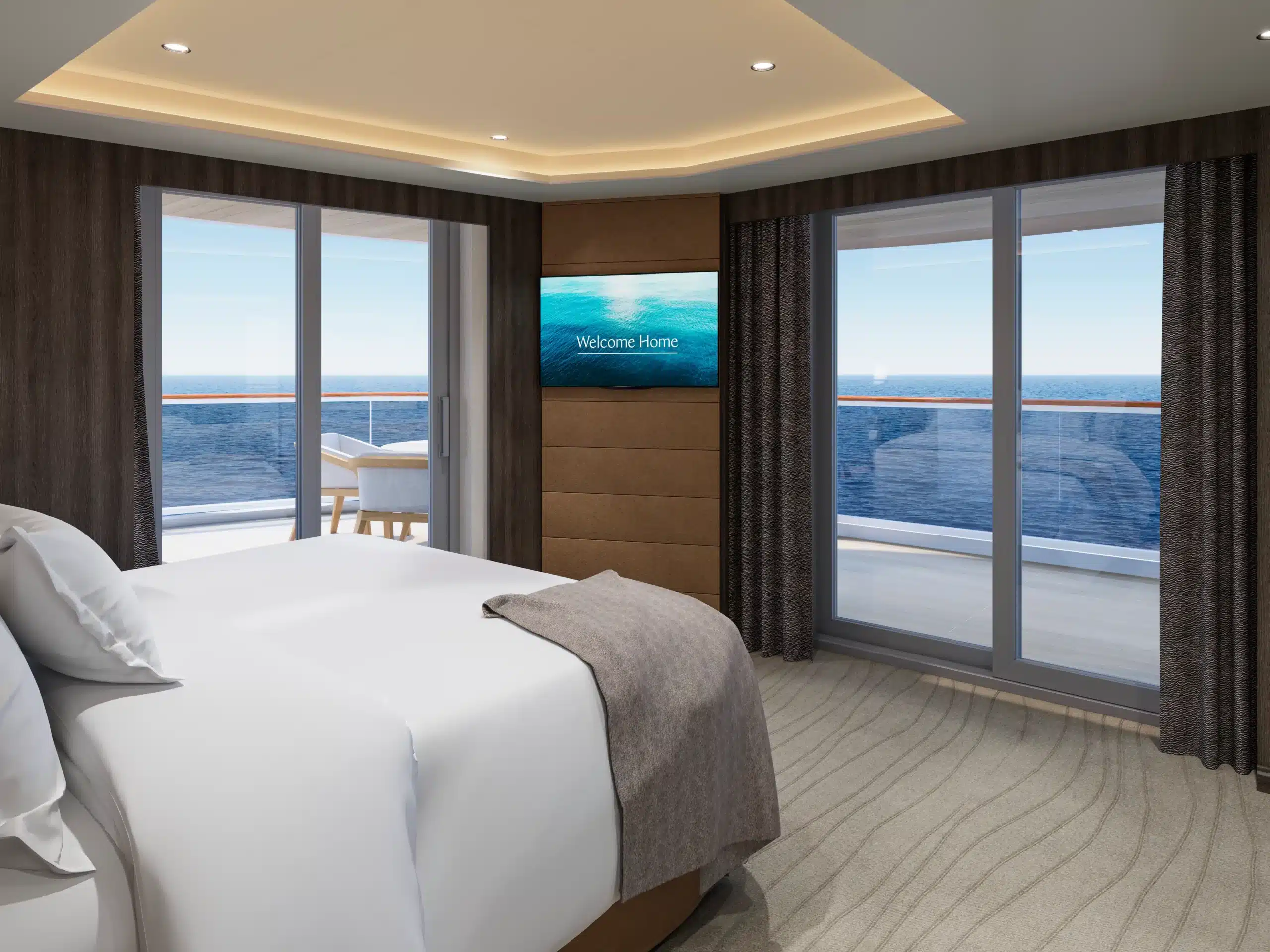Interieur van de Serenity Residence slaapkamer op de EXPLORA V, met een luxueus opgemaakt bed en een glazen deur die leidt naar een privébalkon met uitzicht op de oceaan.