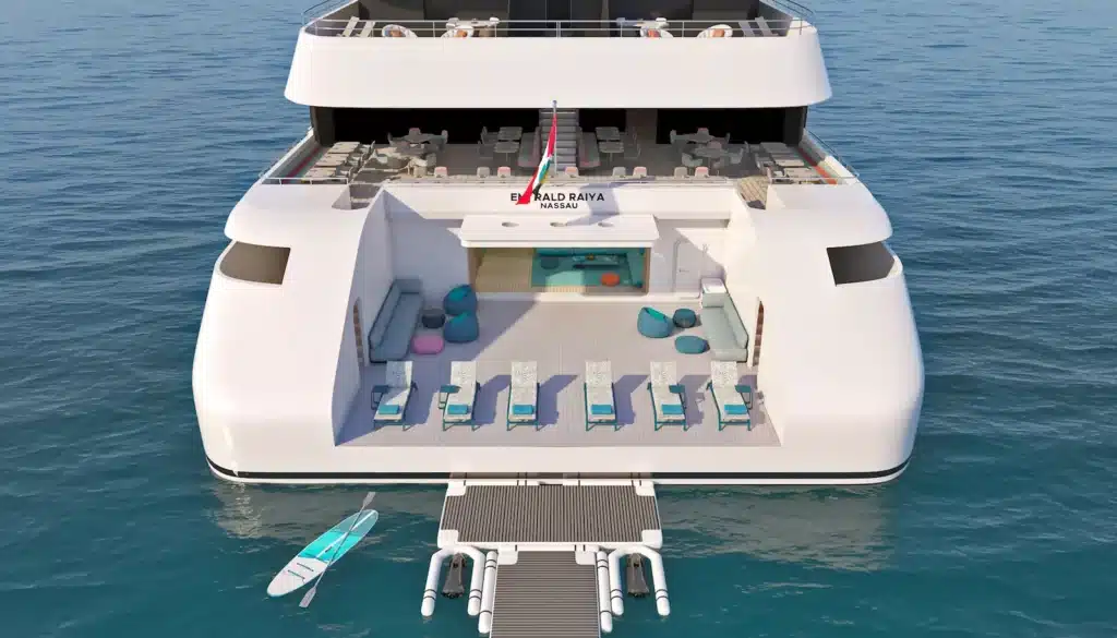 Een achteraanzicht impressie van het luxe cruisejacht Emerald Raiya, met het Marina Deck voorzien van ligstoelen, een loungegedeelte en watersportfaciliteiten zoals een paddleboard.