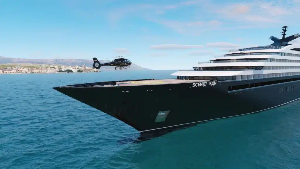 Een rendering van de voorzijde van de Scenic Ikon met een opstijgende helikopter vanaf het helideck op zee.